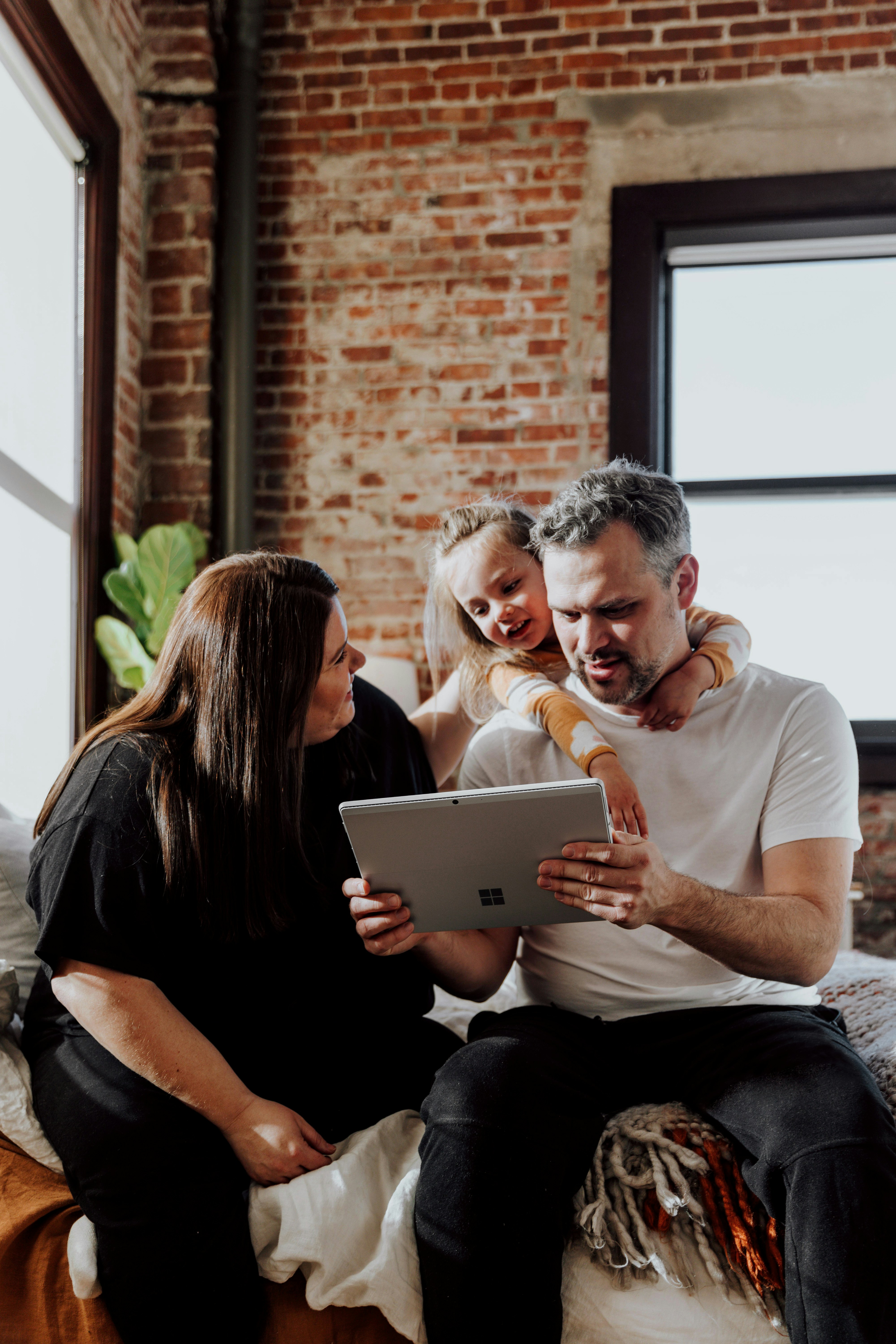 A family looking at a laptop together